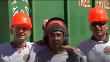 Vegas Best Tree Service crew in hard hats and face shields in front of the company truck